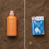 GreenFlow envelope biodegrading in soil next to an unchanged plastic jug